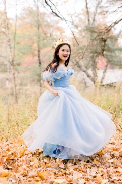 Author Doan Phuong in blue princess dress and crown