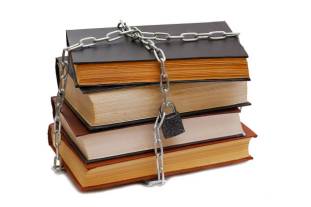 a stack of books chained together banning books creates selective history